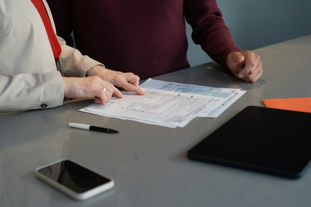 Agent reviewing market comparables with a client at a desk